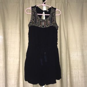 A romper with a very cute embroidered design.